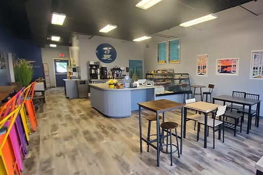 interior of a coffee shop with a variety of tables